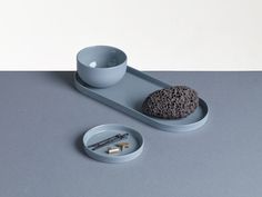 a gray tray with a cup and plate on it