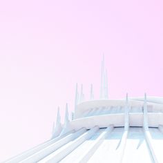 the top of a tall building with white lines on it's sides and a pink sky in the background