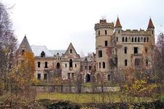 an old castle is surrounded by trees and bushes