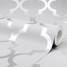 a white and silver wallpaper with circles on it