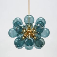 a blue flower shaped light hanging from a ceiling