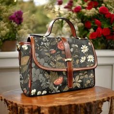 a handbag sitting on top of a wooden table next to some potted flowers