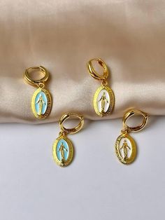 Are you looking for the perfect Virgin Mary earrings for someone special this summer? Or a unique pair of Catholic earrings to spoil yourself? Made with tarnish-free stainless steel, bright white and blue enamel and plated with 18K gold, my delicate Virgin Mary hoops are the perfect compliment to any outfit idea! My 18K gold hoop earrings are a great gift idea for any special occasion to all the women in your life. You can't go wrong when gifting my hoop earrings set to your bestie, wife or sist Virgin Mary Gold Ring, Virgin Mary Jewelry Gold, Virgin Mary Earrings, Catholic Earrings, Gold Virgin Mary Medallion Charm, Spiritual Jewelry: Our Lady Of Guadalupe Round Pendant, Our Lady Of Guadalupe, Lady Of Guadalupe, Gold Signet Ring