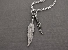 "♥  D E T A I L S -  -  Silver Feathers Necklace  -  Feathers made from alloy with Antique Silver Plating  -  Largest Feather, Actual Size:  1/4\" long x 1 3/4\" long -   Small Feather, Size:  3/16\" wide x 1\" long -   Nice detailing -   314L Stainless Steel Cable chain, Links measure appx 3mm wide -   Lobster clasp closure -   Very fluid movement of the chain -   A nice chain and beautiful draping qualities -   Chain is waterproof but the pendant is not ♥  This handsome man's necklace is one y Silver Feather Necklace, Fluid Movement, Large Feathers, Lubbock Tx, 16 Inch Necklace, Feather Necklace, Stainless Steel Cable, Feather Pendant, Silver Feather