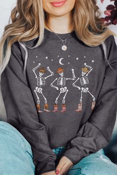 Dancing Skeleton Sweatshirt | Skeleton Cowgirl Shirt | Western Halloween | Boot Scootin' Spooky :star: • I T E M • I N F O•✦ Gildan Unisex Sweatshirt✦ This is made from a cozy, thinner material- perfect year round! ✦ Printed using Direct To Garment style- Inks are printed directly into the fabric.✦ Different sizing may effect placement of final design.✦ Colors may differ slightly due to different user monitor and screen settings. Skeleton Cowgirl, Boho Skeleton, Drop Everything Now, Boot Scootin Spooky, Halloween Boots, Etsy Halloween, Western Sweatshirts, Skeleton Hoodie, Skeleton Sweatshirt