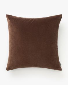 a brown pillow on a white background