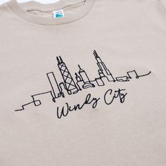 a t - shirt with the words wine city written in black ink on it's front