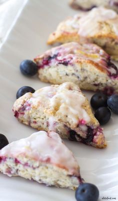 blueberry scones with icing on a white plate