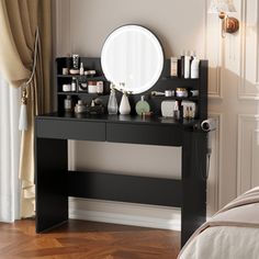 a bedroom with a large mirror on the wall and a black vanity in front of it