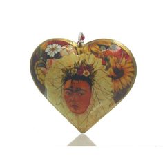 a heart shaped glass ornament with sunflowers and a woman's face