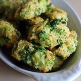 broccoli florets are in a white bowl on a counter top, ready to be eaten