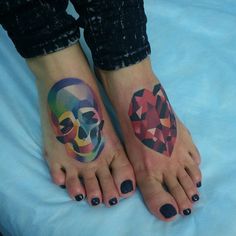 two feet with tattoos on them and one has a skull in the middle, while the other