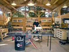 a man is working in a woodworking shop with his workbench and tools