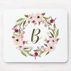 a floral wreath with the letter b in it's center on a white mouse pad