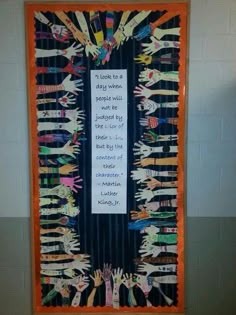 a bulletin board that has been decorated with children's handprints on it