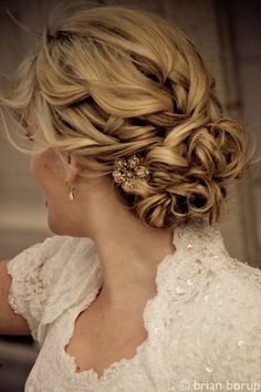 the back of a woman's head with braids in her hair, wearing a wedding dress