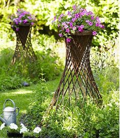 two tall planters with purple flowers in them