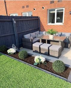 an outdoor patio area with furniture and flowers