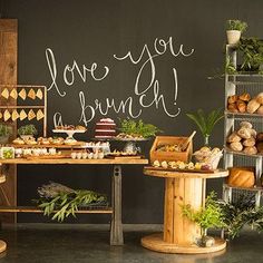 an assortment of baked goods on display in front of a chalkboard that says love you, brunch