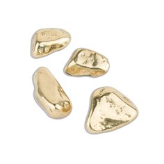 three pieces of gold colored metal on a white background