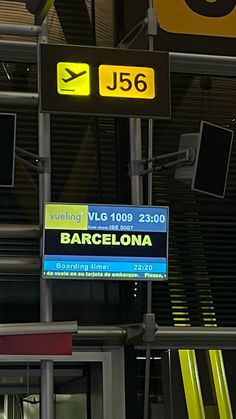 there are many signs in the building that say barcelona and j6, including an airplane