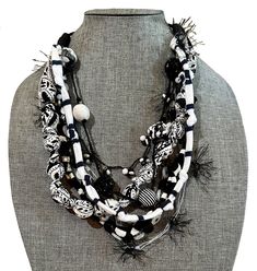 "Each one is handmade by textile designer Lynn Reiter Weinberg in her Ga. Studio using assorted black and white yarns, recycled fabrics, buttons, hand knotted fabric beads, crocheted threads and assorted handmade fiber and non-precious beads. There are a total of 7 strands all in black and white.  This light necklace is ideal for women who love the look of statement necklaces, but without the weight around their neck. Versatile and perfect for any season and any occasion. Looks great with a dres Fabric Necklaces, Black And White Necklace, Light Necklace, Fiber Necklace, Dress Business, Precious Beads, Fabric Necklace, Textile Designer, Fabric Beads