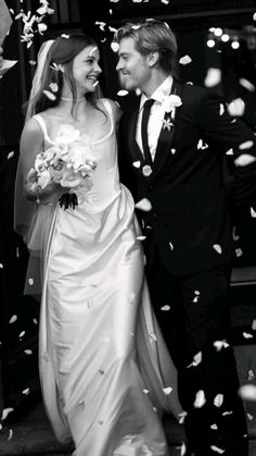 a newly married couple walking through confetti