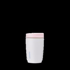 a white and pink coffee cup sitting on top of a table