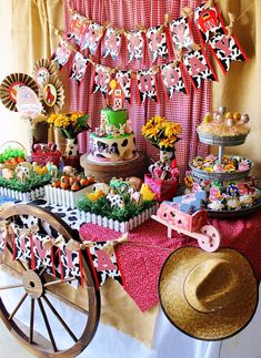 a table topped with lots of cakes and desserts