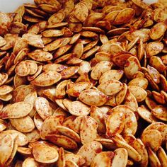 a pile of pumpkin seeds sitting on top of a table