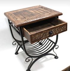 a wooden table with two drawers on it's sides and an iron frame around the top