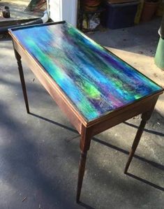 a wooden table sitting on top of a sidewalk