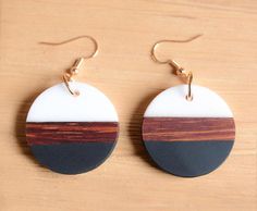 two round wooden earrings with black, white and brown stripes