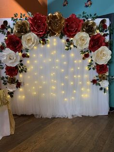 the backdrop is decorated with red, white and gold flowers