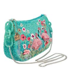 Step into a tropical paradise with this flamboyant flamingo crossbody handbag, Where shimmering turquoise beadwork meets a flock of playful pink fringe. Surrounded by a flourish of embroidered flowers. This beautiful handbag has a roomy interior to accommodate all your essentials. 9.75 x 3 x 6" Strap Length End to End: 49" Strap Drop: 23" Non-removable crossbody chain strap Zipper closure Inside pocket Back pocket Fits a phone Includes: metal logo fob, protective storage bag, certificate of auth Funky Purses, Mexican Colors, Bear Bag, Mary Frances, Fancy Bags, Beautiful Handbags, Pretty Bags, Metal Logo, Beaded Bags