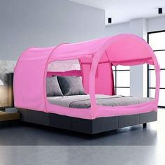 a bed with a pink canopy over it