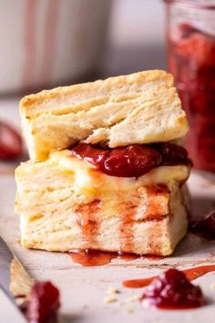 two biscuits stacked on top of each other with jam in the background