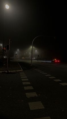 an empty street at night with the lights on