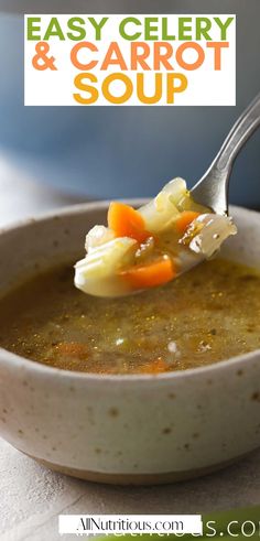 a spoon full of soup with carrots and celery