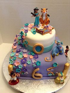 the cake is decorated with disney characters and flowers