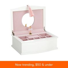 a white jewelry box with an open lid and pink linings on the inside, holding a mirror