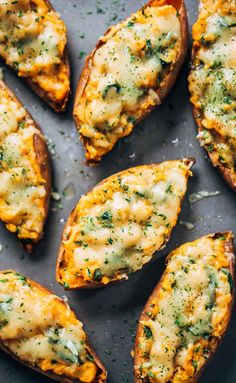 baked potatoes with cheese and herbs on a baking sheet