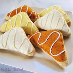 four pieces of bread with white icing on a plate