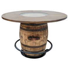 a wooden barrel table with a glass top