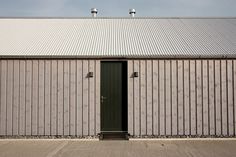 a building with a metal roof and two doors