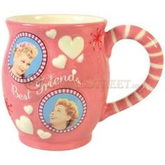 a pink coffee mug with pictures of marilyn monroe and hearts on the inside, in front of a white background