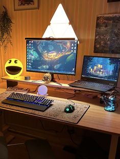 two computer monitors sitting on top of a desk next to a keyboard and mouse pad