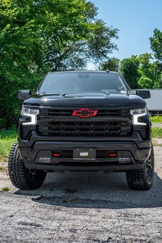 The grille of a blackout 2022 Chevy Silverado with a custom red and black Chevy emblem Big Chevy Trucks, New Chevy Truck, Chevy Silverado Accessories, Chevy Silverado Z71, Silverado Accessories, New Chevy Silverado