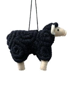 a black and white stuffed animal hanging from a string