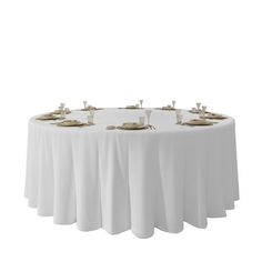 a round table with white linens and gold place settings on the top is shown